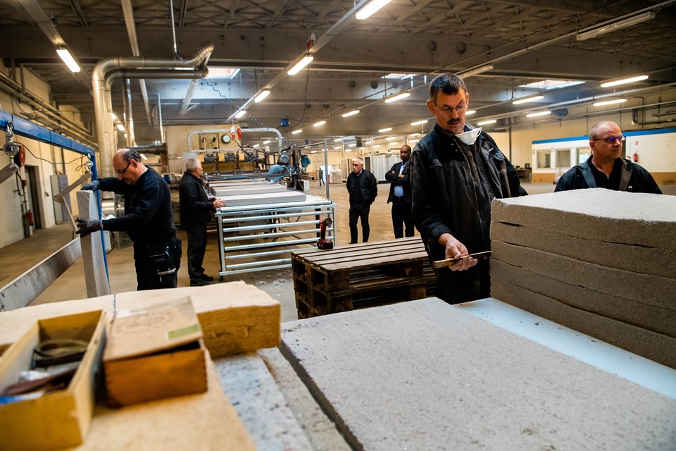 Tirsdag 9. oktober sker det endelig - ovnen virker og den første produktion af en isoleringsmåtte af avispapir gennemføres. Her er medarbejderne i gang med at kvalitetstjekke materialet. I baggrunden ses en delegation fra Sydafrika, der er på besøg for at overveje, om de skal investere i denne form for teknologi. Fra venstre Hartmut Pousset, Henning Bang, Henning Møller og Kim Andersen. Foto: Diana Holm Lone Lærke Krog